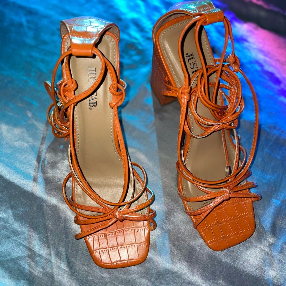 Lace up orange chunky heels.